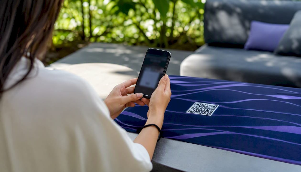 Person scanning guest Wi-Fi QR code