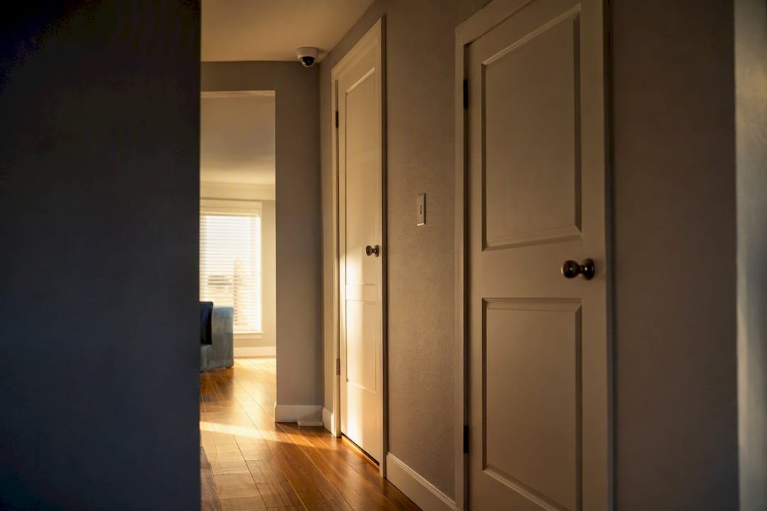 Indoor security camera mounted high in hallway corner