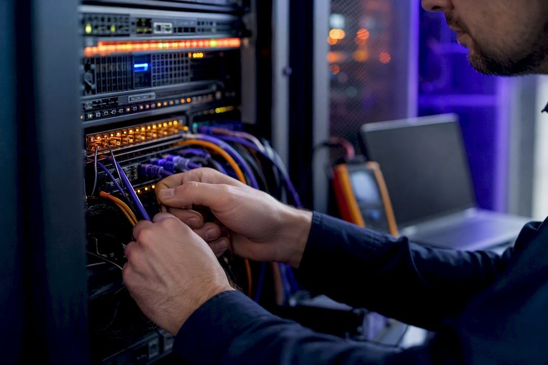 Technician hands managing server cables