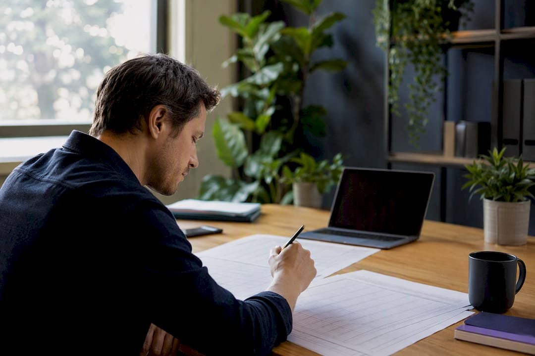 Hands calculating website costs on desk